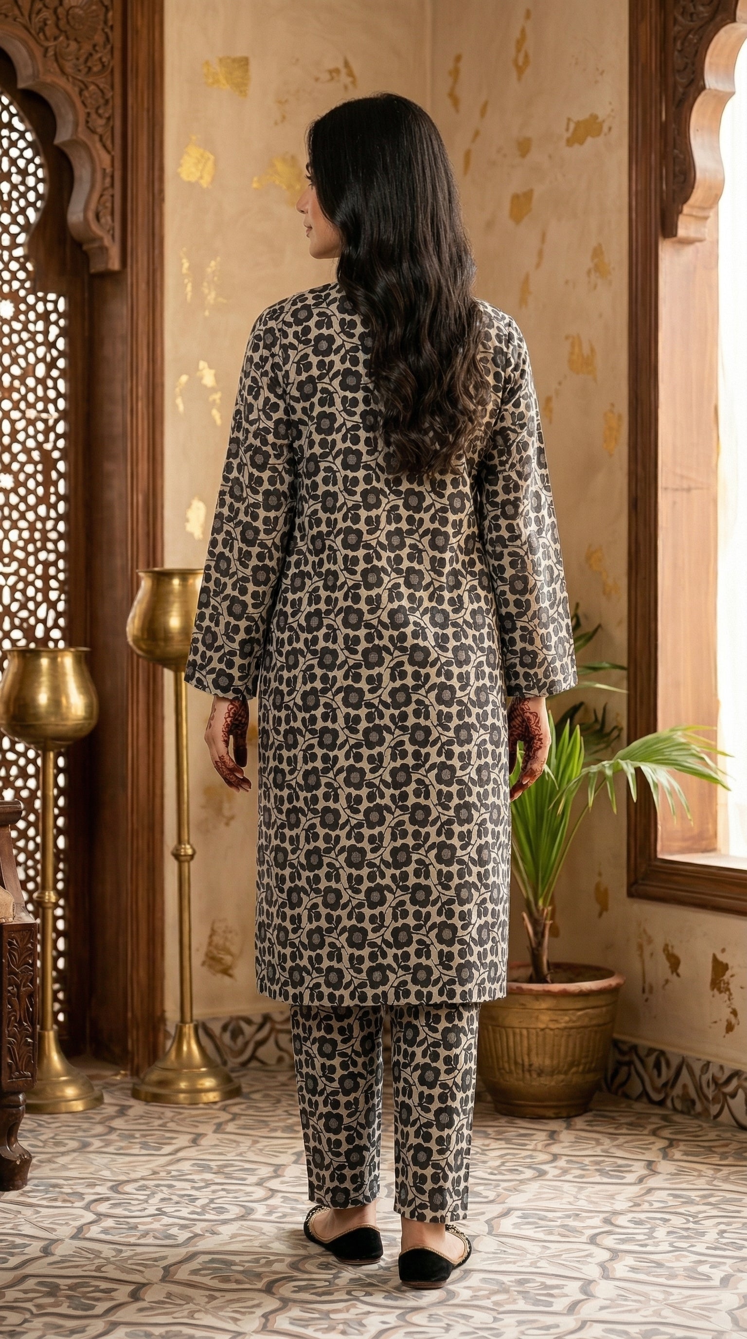 Back view of black and beige floral printed long shirt with coordinated straight trousers.