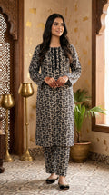 Front view of black and beige floral printed women stitched suit with matching straight trousers.