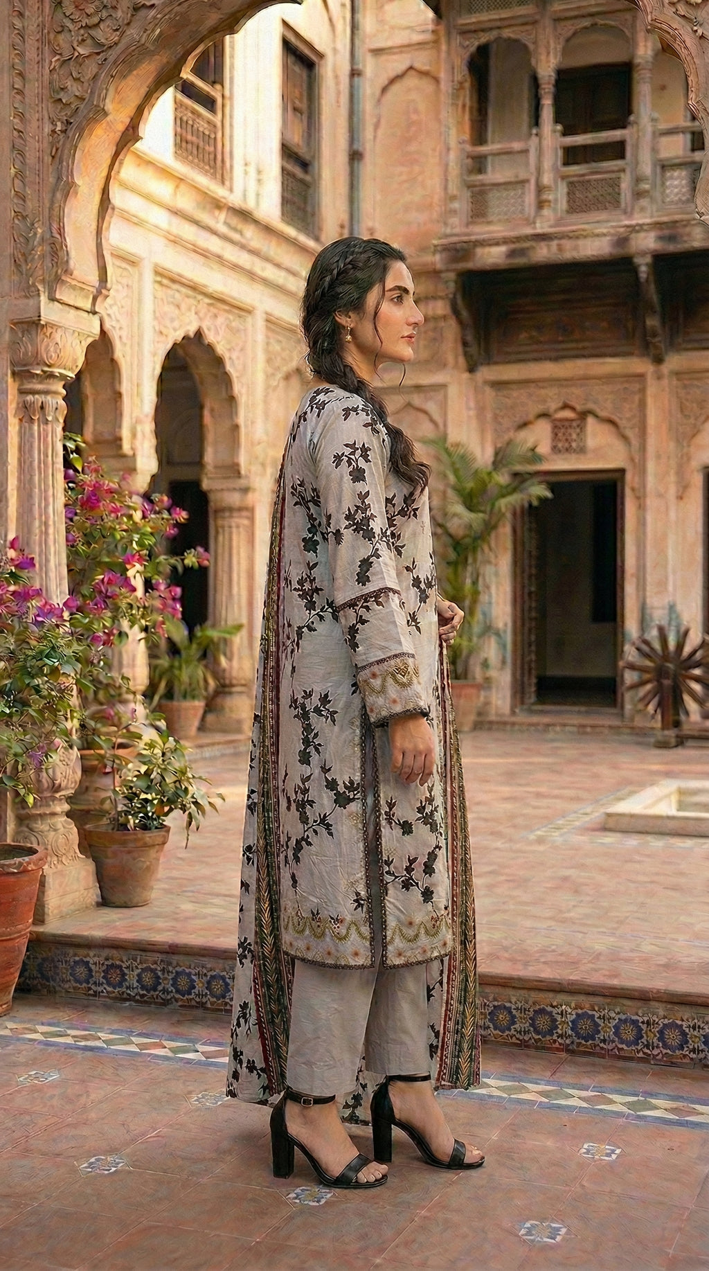 Side profile of elegant grey ethnic suit with flowing dupatta. Luxury women ethnic wear sapphire suit with floral printed dupatta.